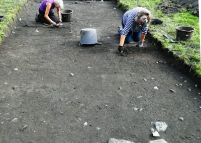 Big Dig 2021 Trench 12 after 3 days of patient trowelling, the emerging cemetery wall at the far end. 9.09.21