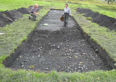 Big dig 2021 Trench 12 - Gordon and Mary-Ann revealing the cobbled surface. 24.09.2021